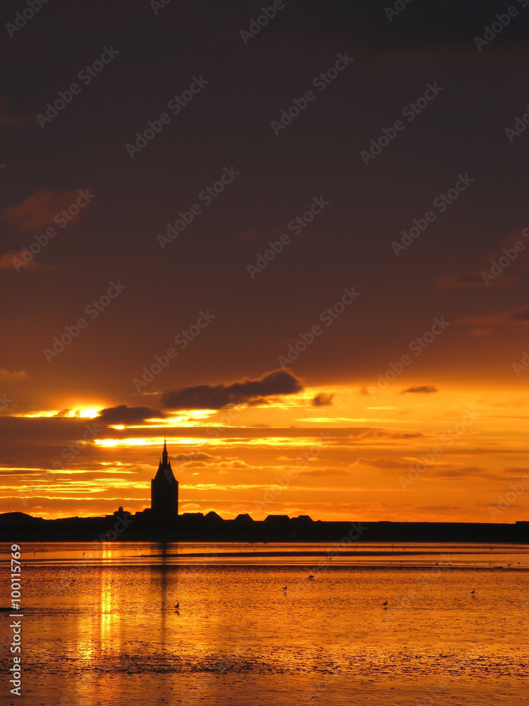 Silhouette of church of the East Frisian island Wangerooge at sunset, Germany Silhouette of church of the East Frisian island Wangerooge at sunset, Germany