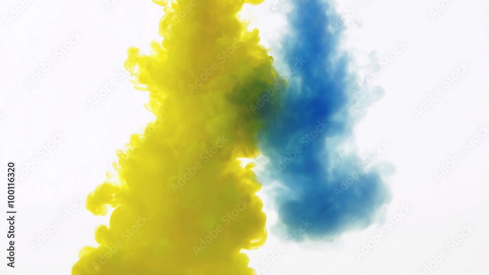 yellow and blue ink reacting in water.Creative slow motion. On a white background. yellow and blue ink reacting in water.Creative slow motion. On a white background.