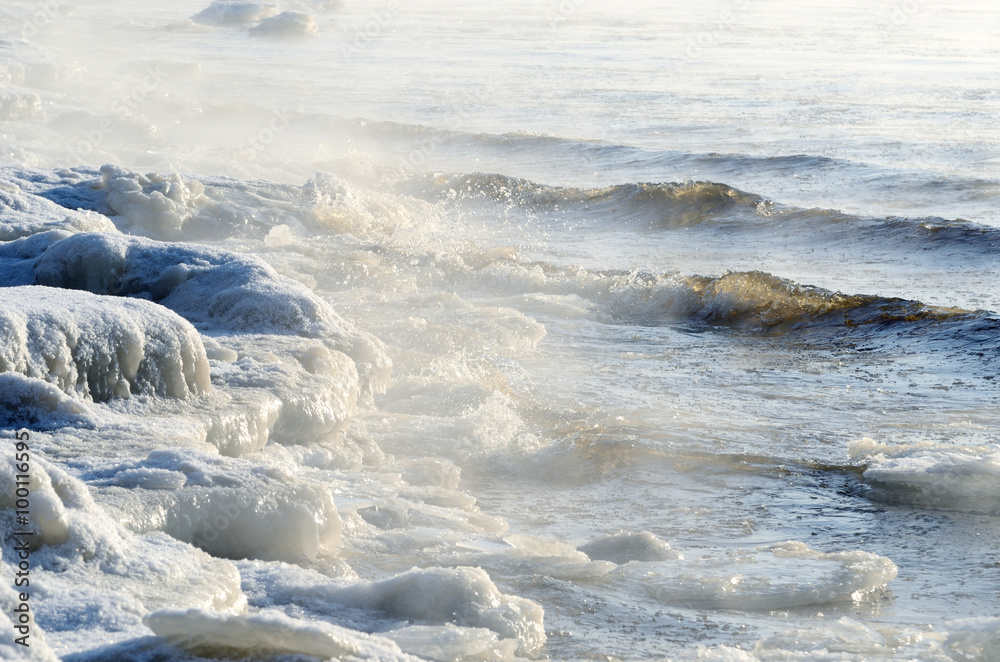 frozen sea view. Waves hitting icy coastline