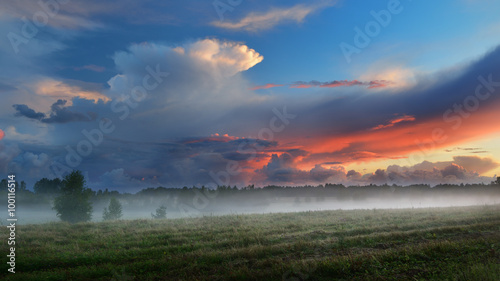 Sunset over a misty field in countryside Latvia
