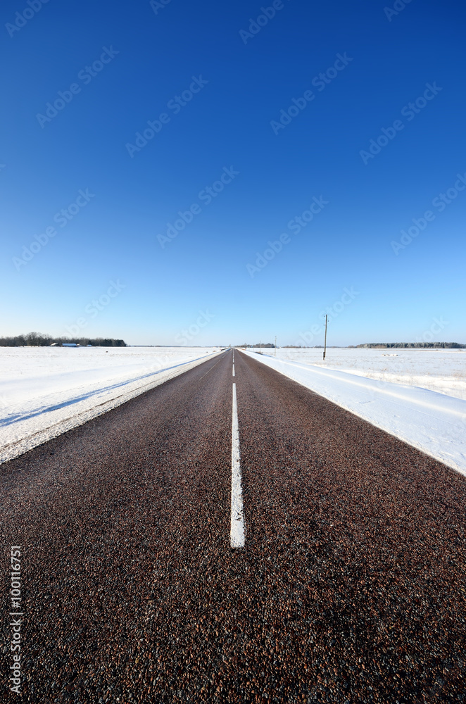 classic winter scene of a highway in rural area