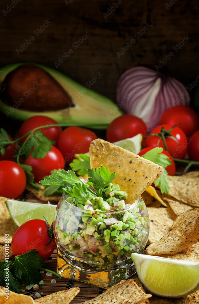 Mexican fast food, corn nachos with guacamole sauce with avocado Mexican fast food, corn nachos with guacamole sauce with avocado
