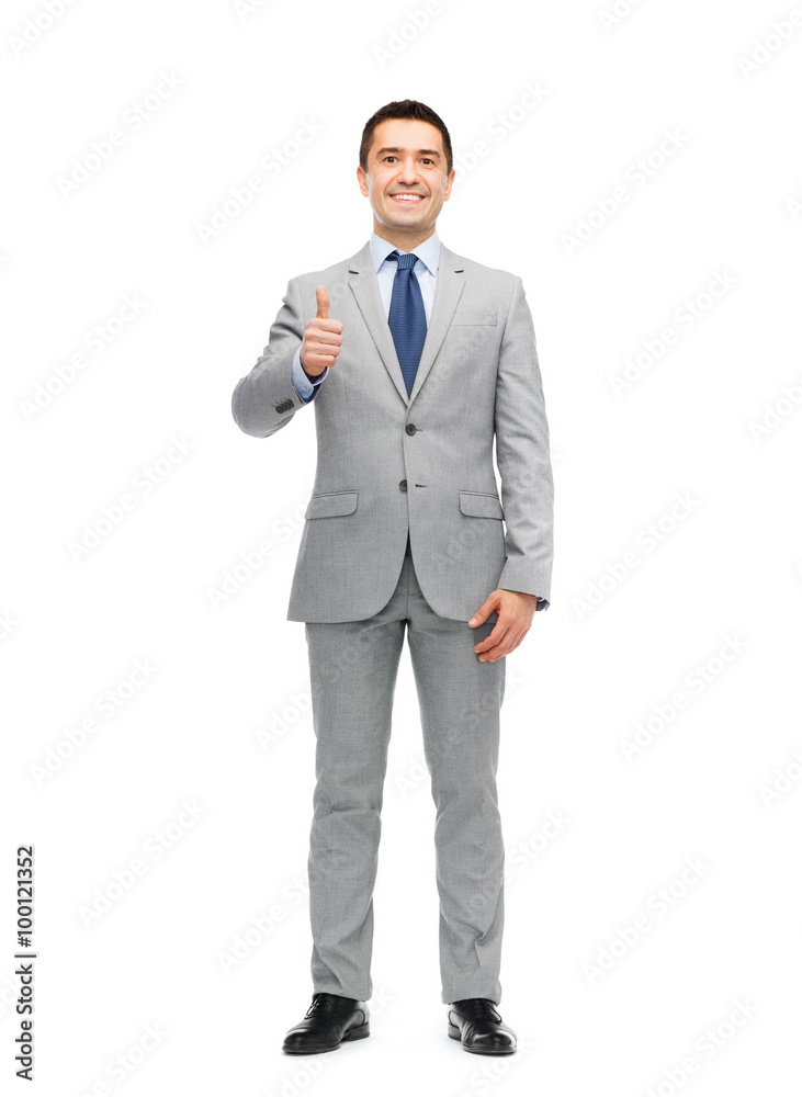 happy businessman in suit showing thumbs up happy businessman in suit showing thumbs up