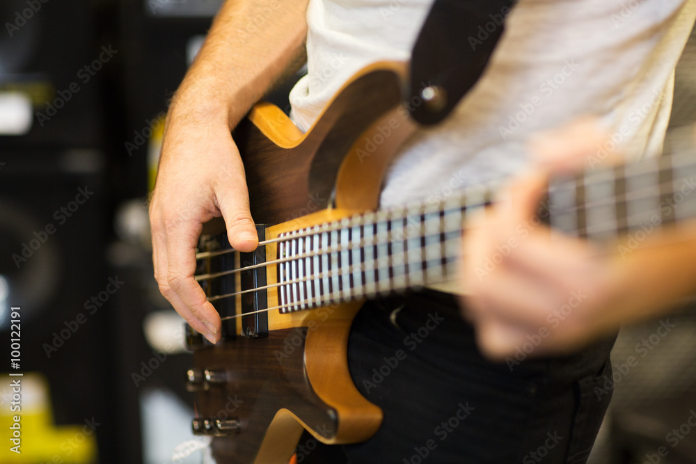 close up of musician with guitar at music studio