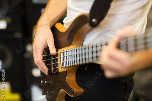 close up of musician with guitar at music studio