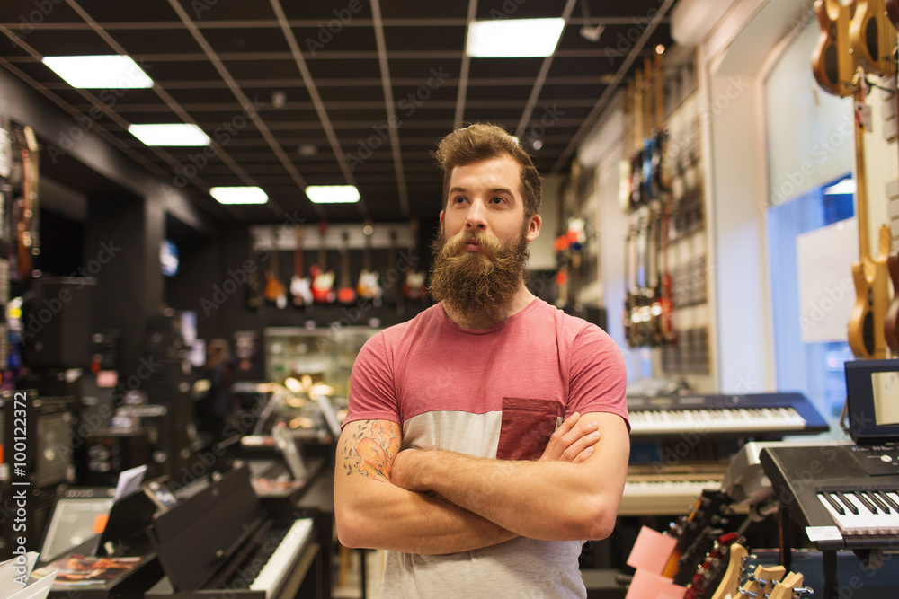 assistant or customer with beard at music store
