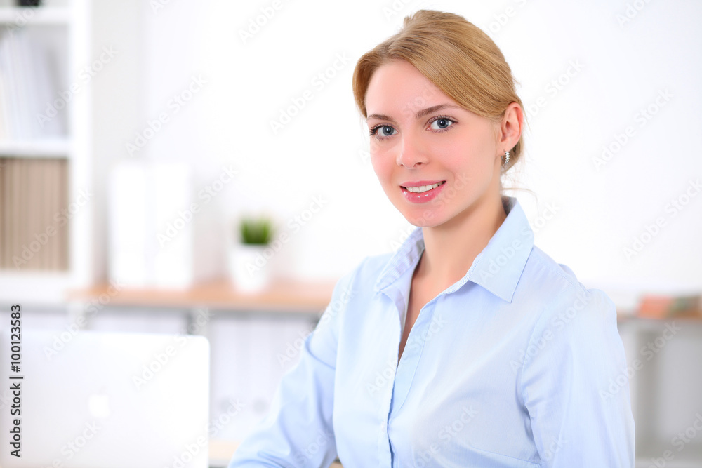 Young blonde business woman with laptop in the office. Business concept. Young blonde business woman with laptop in the office. Business concept.