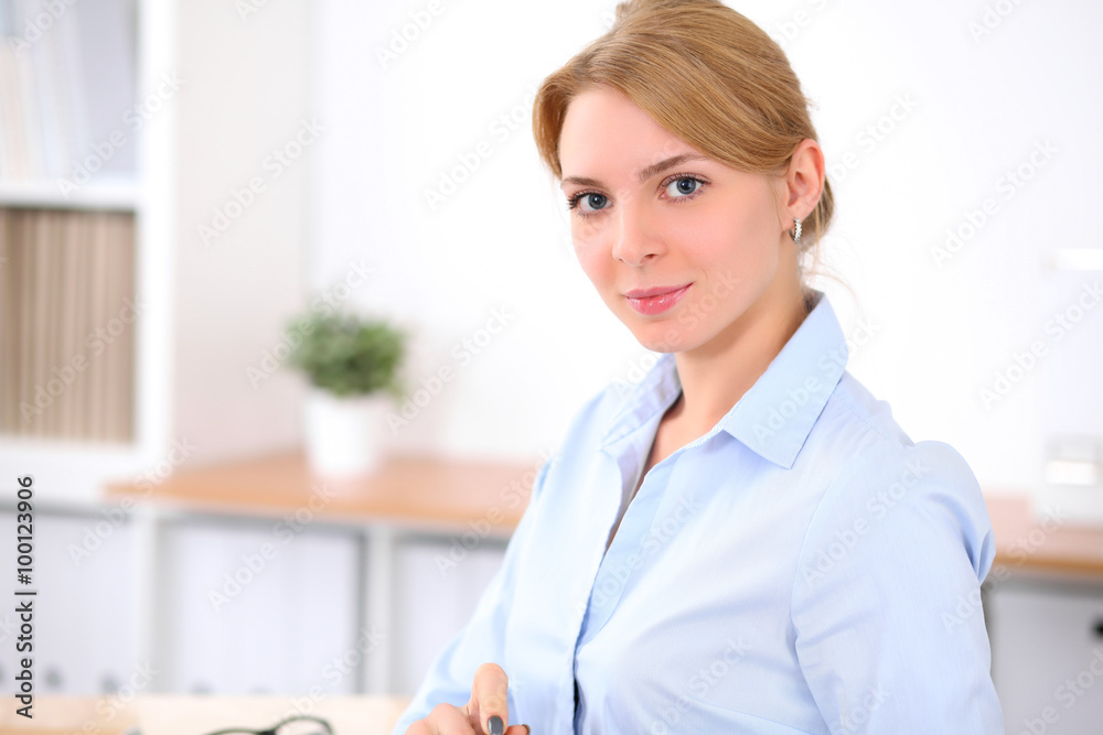 Young blonde business woman with laptop in the office. Business concept. Young blonde business woman with laptop in the office. Business concept.