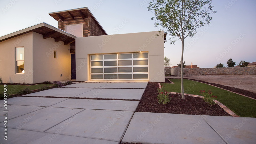 Rising Up to Modern Southwestern New Home. camera rises from the front lawn to reveal modern southwestern home during sunrise. Unique style for the area.
