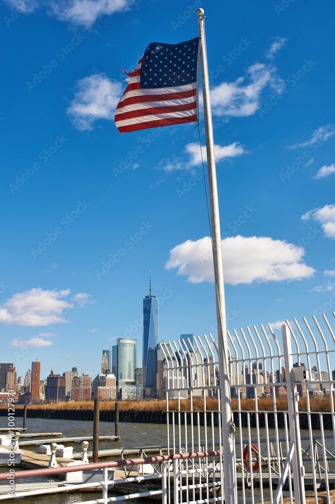 American flag with Manhattan skyline at background