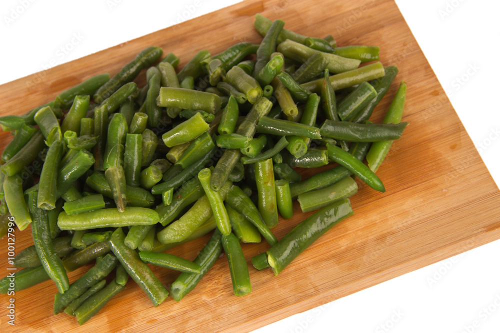 Green string beans on a wooden board Green string beans on a wooden board