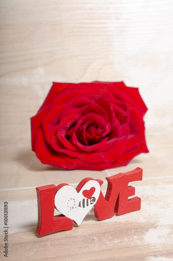 Fototapeta premium Wooden background with love word and heart as a concept of Valentines day and Love 