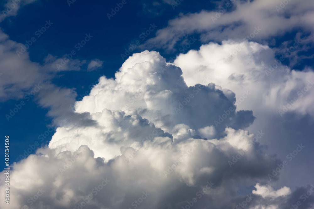 Large cumulus clouds against a bright blue sky closeup Large cumulus clouds against a bright blue sky closeup