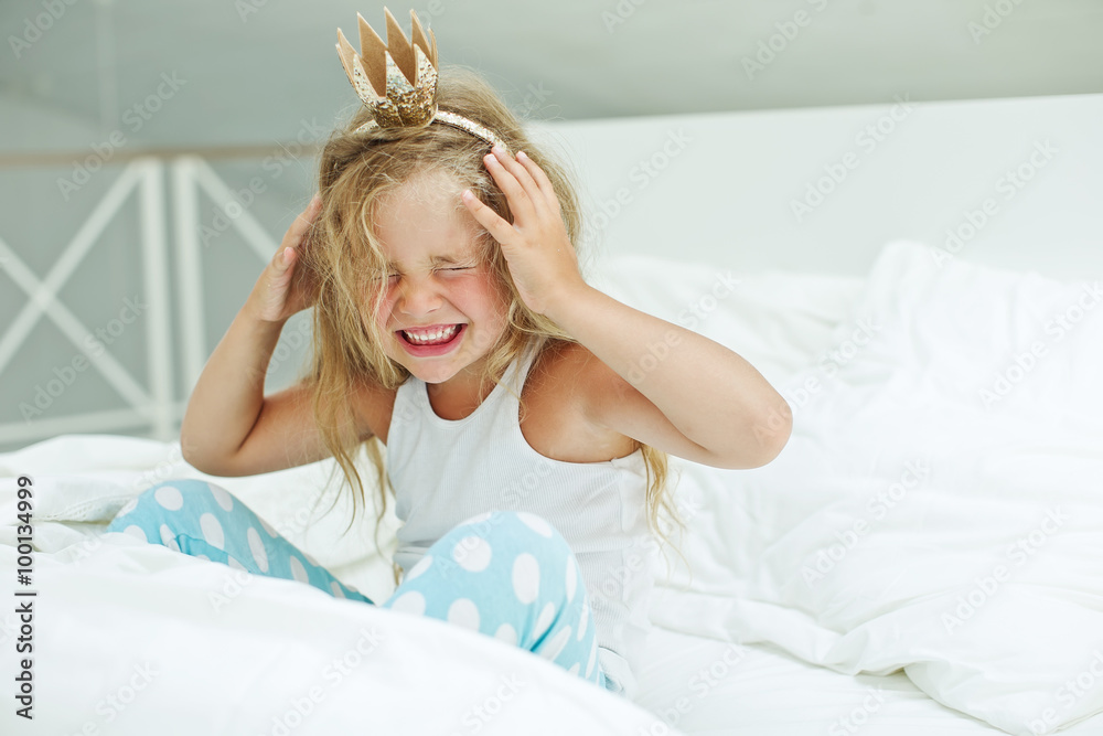 Fototapeta premium Little happy princess are playing in the bed