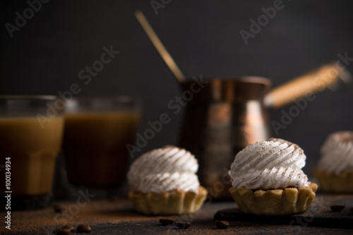 Creamy cake on the dark rustic background. Shallow depth of field.
