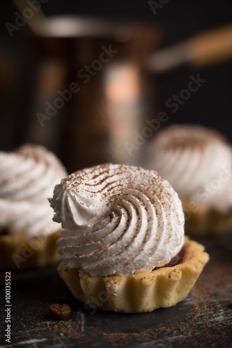Creamy cake on the dark rustic background. Shallow depth of field.