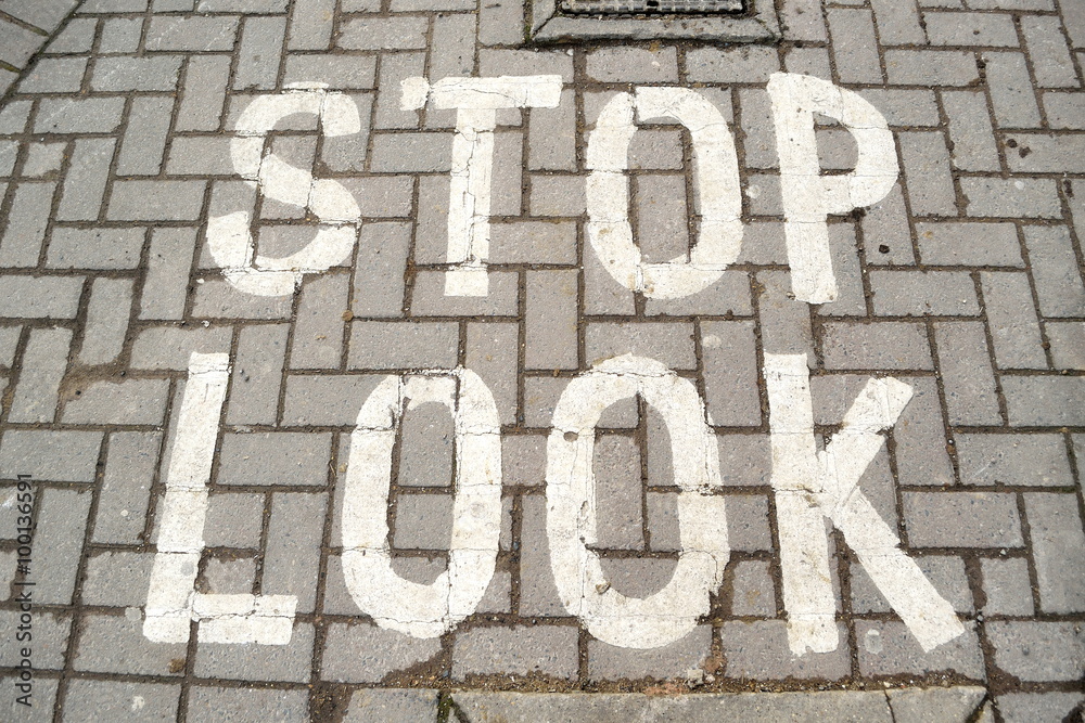 stop-look written sign on pavement made of bricks stop-look written sign on pavement made of bricks