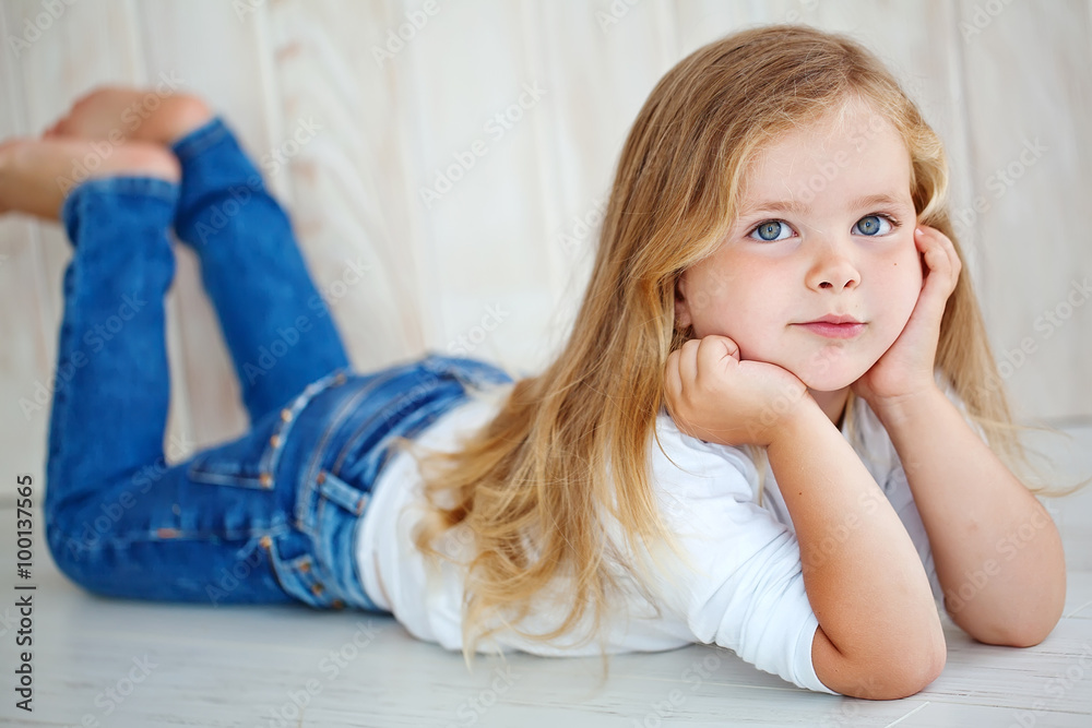 Beautiful little girl lying on the floor Beautiful little girl lying on the floor
