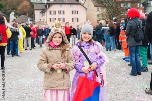 Two little girls participating in traditional european february carnival
