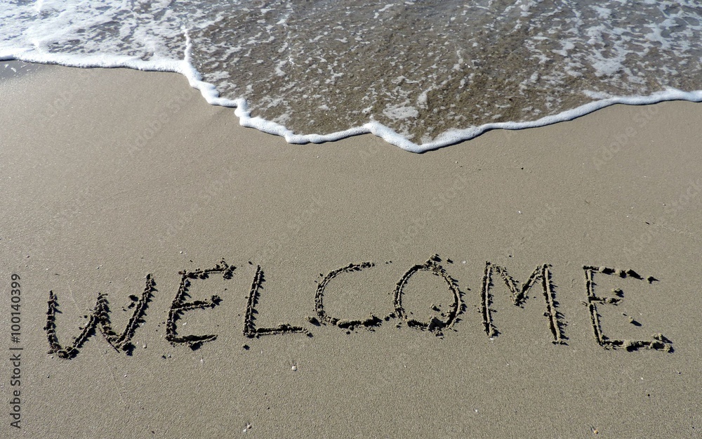 Fototapeta premium Inscription Welcome on wet sand.