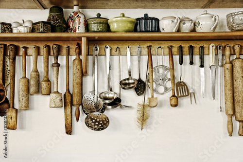 Old kitchen ware hanging on the wall. photo