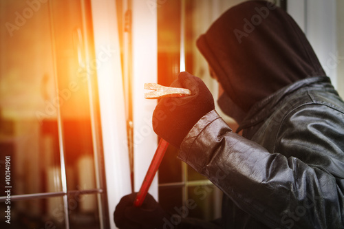 Burglar breaking in a house