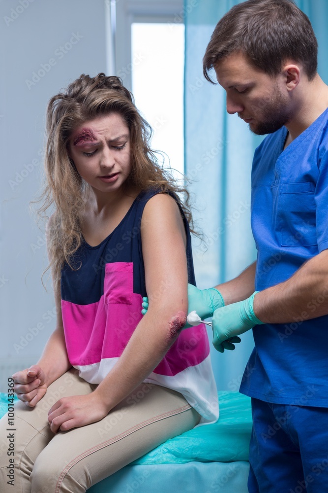 Obraz premium Paramedic cleaning the wound