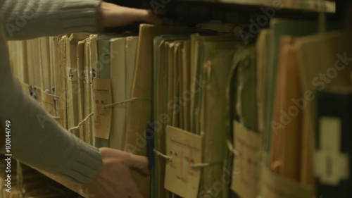 Man looking documents in the archive photo