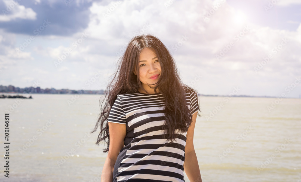 Attractive asian girl at the beach - people, lifestyle concept Attractive asian girl at the beach - people, lifestyle concept