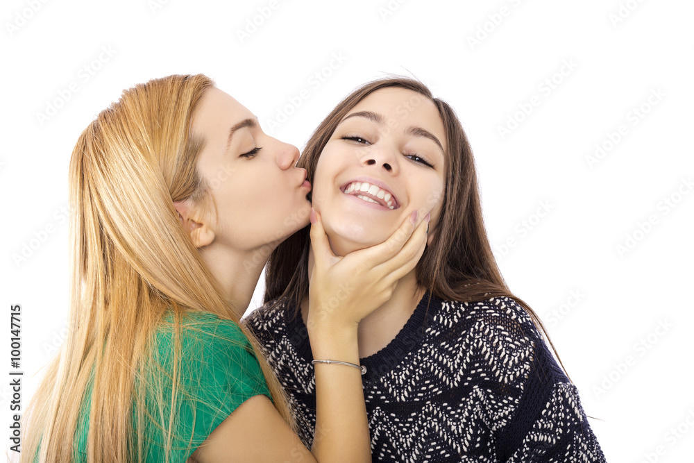 Two funny affectionate teenage friends laughing and kissing Two funny affectionate teenage friends laughing and kissing