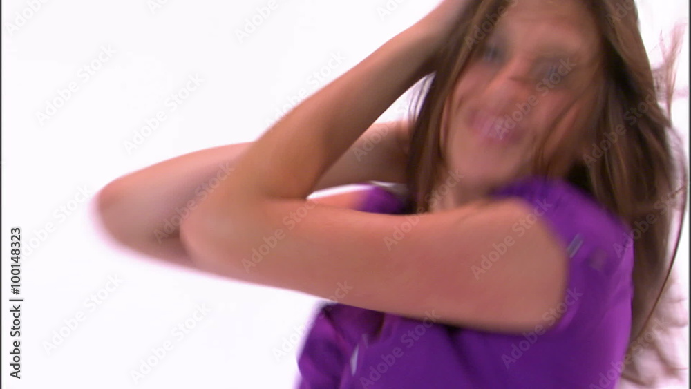 Tilt down shot of a dancing girl in a purple shirt. Tilt down shot of a dancing girl in a purple shirt.