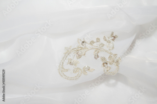 Embroidery with stones on a white wedding dress