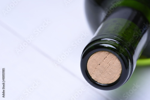 Macro of wine bottle with cork on wooden board
