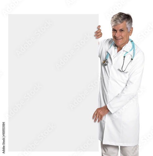 Full length portrait of medical doctor looking at blank billboar photo