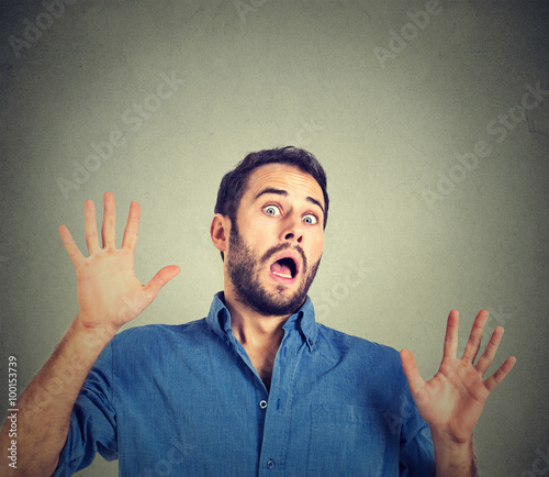 scared man on gray wall background .