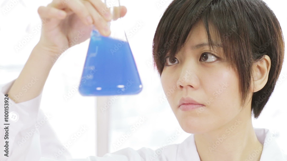 Asian scientist inspecting erlenmeyer flask Asian scientist inspecting erlenmeyer flask