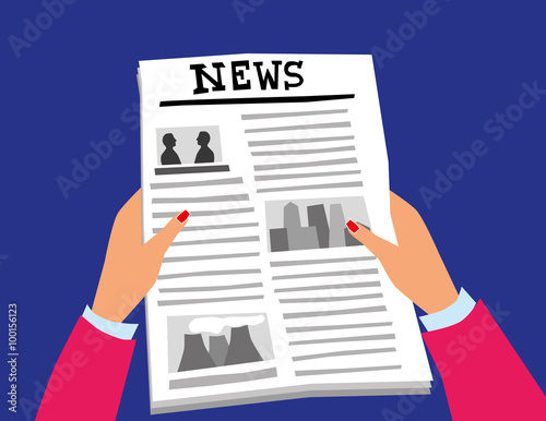 Female hands with nail varnish holding a newspaper with pictures and text in the layout