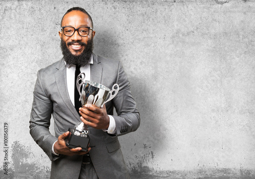 business black man holding a trophy