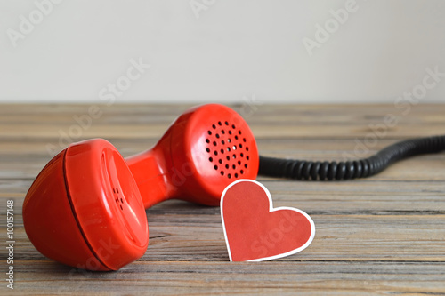 Vintage red telephone handset and heart shaped tag