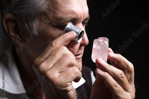 portrait of a jeweler during the evaluation of jewels. photo