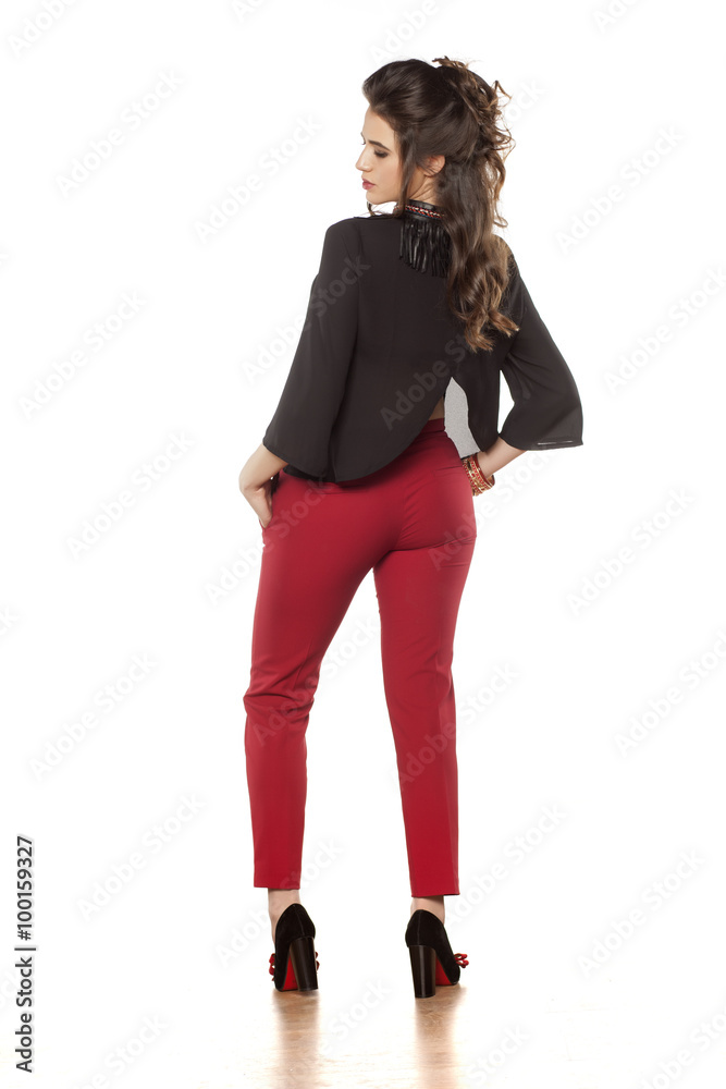 attractive brunette in red pants posing in the studio attractive brunette in red pants posing in the studio