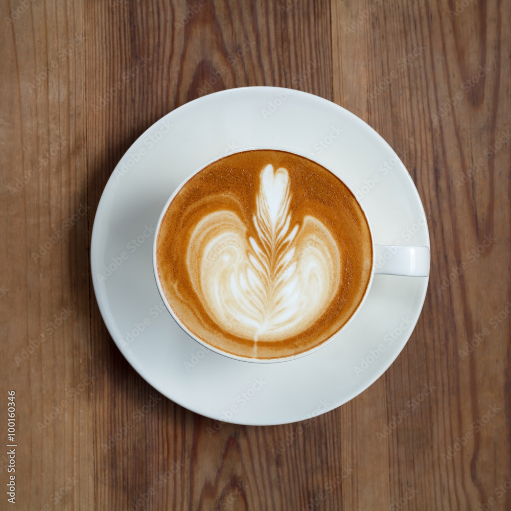 Top view latte art coffee on wood background Top view latte art coffee on wood background