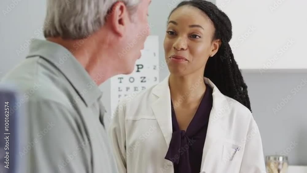 Black woman doctor talking and being positive with senior Black woman doctor talking and being positive with senior
