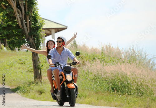 Happy couple on a scooter photo