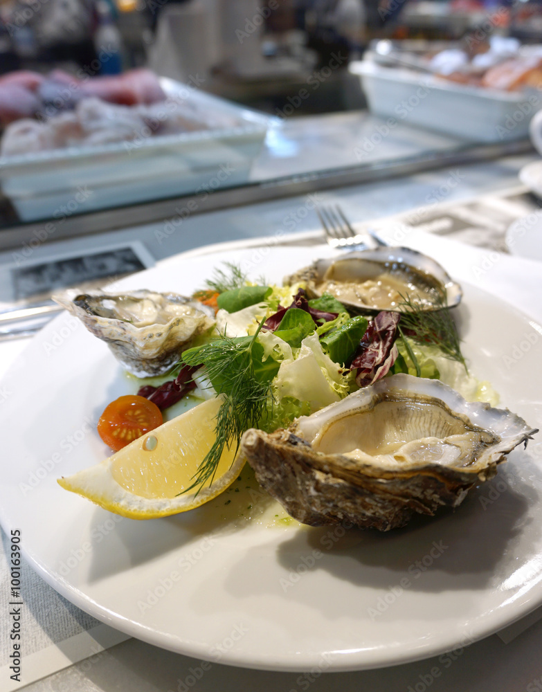 fresh oysters serving with salad