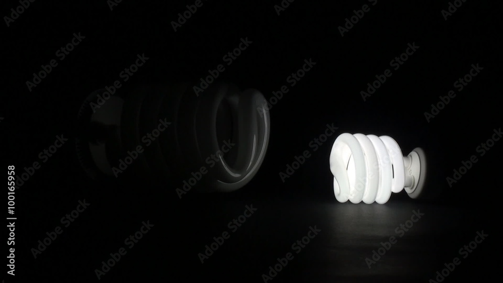 Comparing small and huge fluorescent light in dark room against black background. Turning on huge bulb while small one is already on. Comparing small and huge fluorescent light in dark room against black background. Turning on huge bulb while small one is already on.