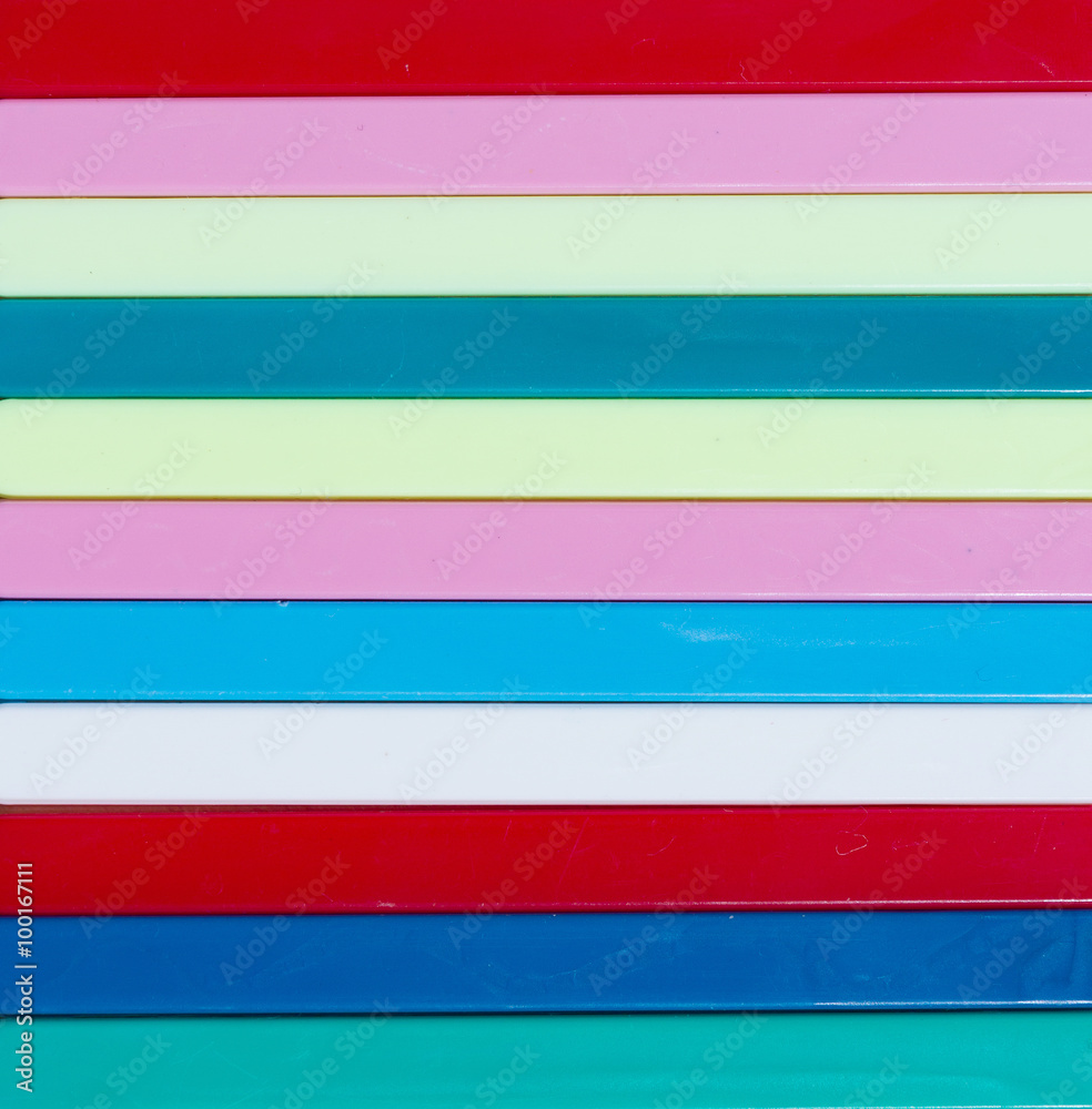Colorful striped background. Plastique sticks of different color