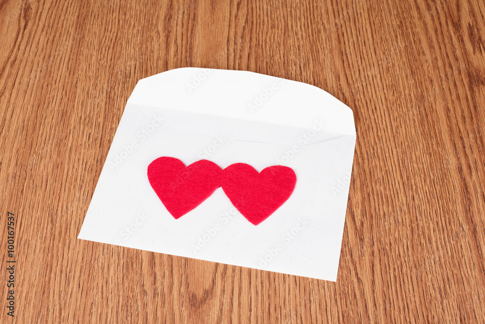 Red heart shape on white envelope Red heart shape on white envelope