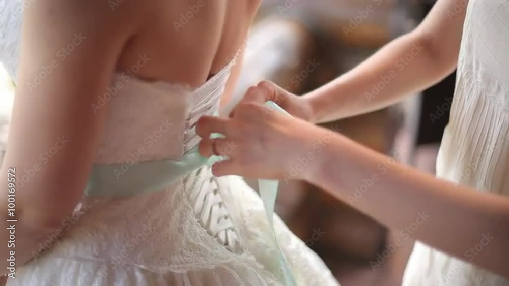 Help the bride to wear a wedding dress Help the bride to wear a wedding dress