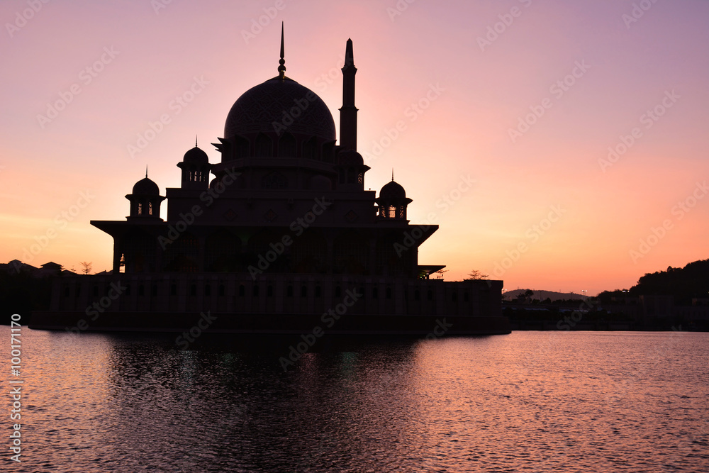 Silhouette of Putra Mosque during sunrise in Putrajaya, Malaysia.